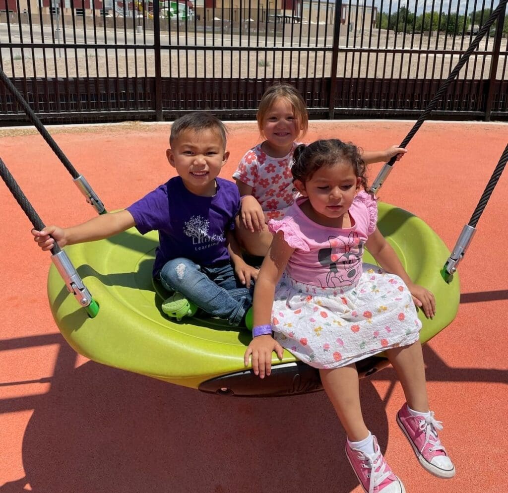 sensory park 3 After-School and Summer Program kids sitting in a green swing