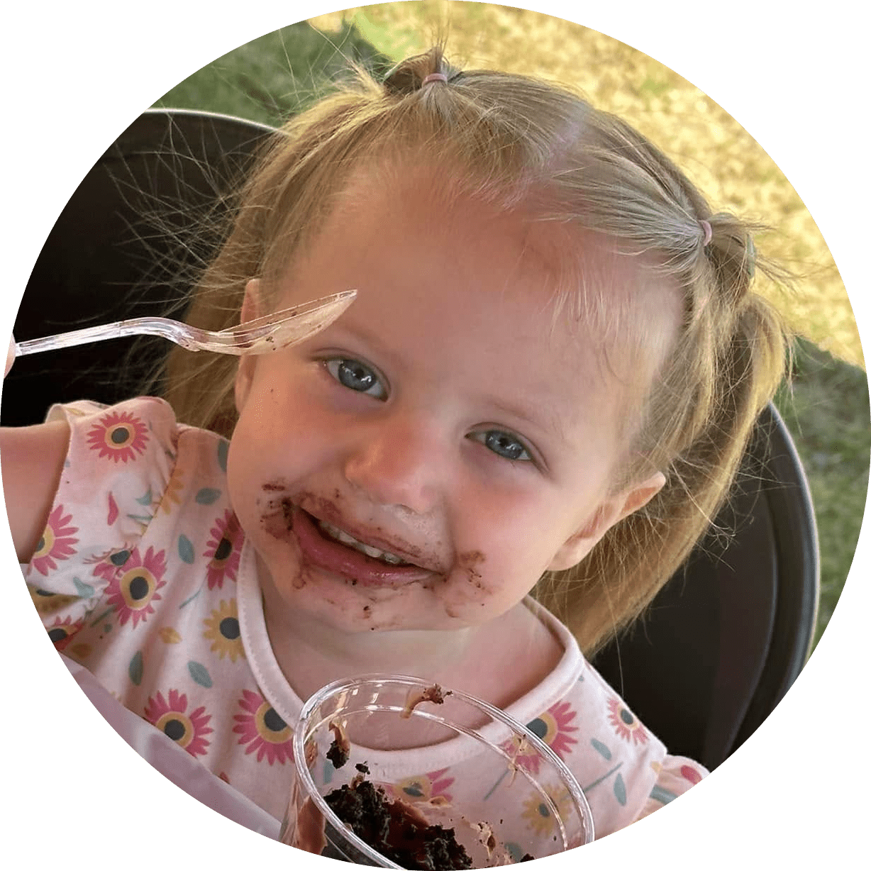 A little girl is eating "dirt" made out of Oreos with gummy worms in it 