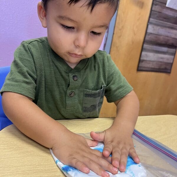 boylearningcenter A little boy is making a tie-dye shirt